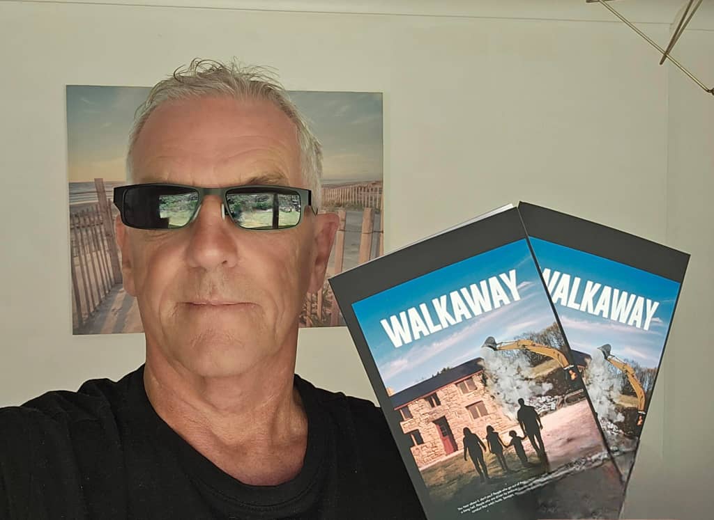 Author holding the hard copy of the book